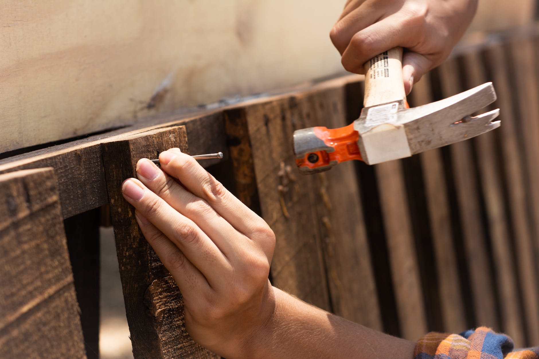 a person hammering a nail