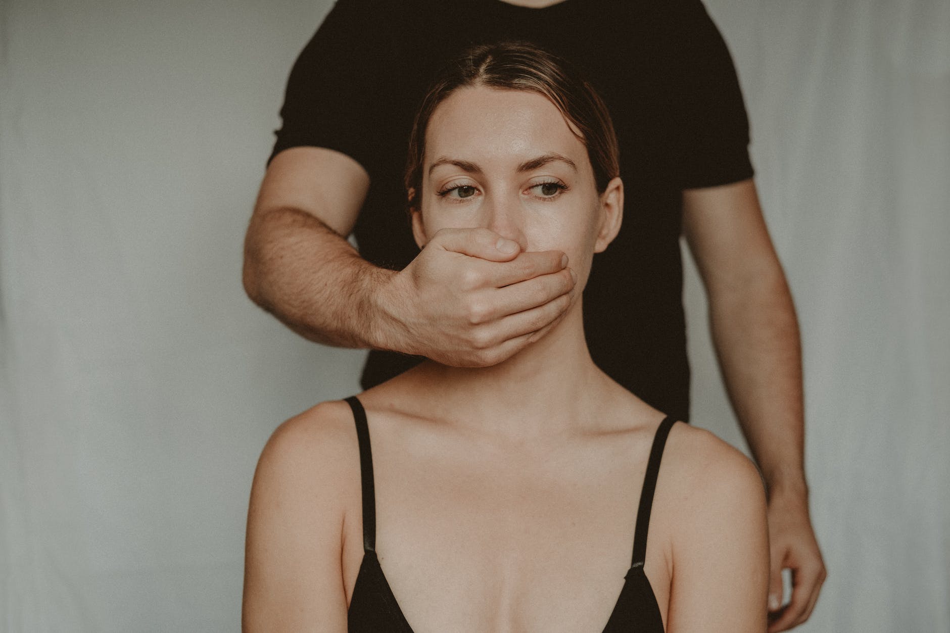 crop man covering mouth of woman